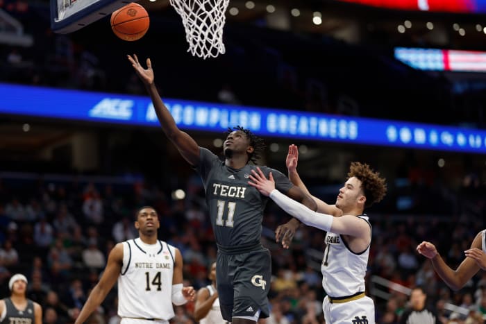 Mar 12, 2024; Washington, D.C., USA; Georgia Tech Yellow Jackets forward Baye Ndongo (11) shoots the ball as Notre Dame Fighting Irish guard Braeden Shrewsberry (11) defends in the first half at Capital One Arena. Mandatory Credit: Geoff Burke-USA TODAY Sports
